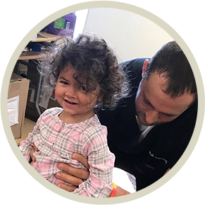 Dr. Ellensohn adjusting a toddler