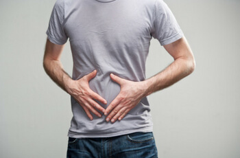 Man holding stomach